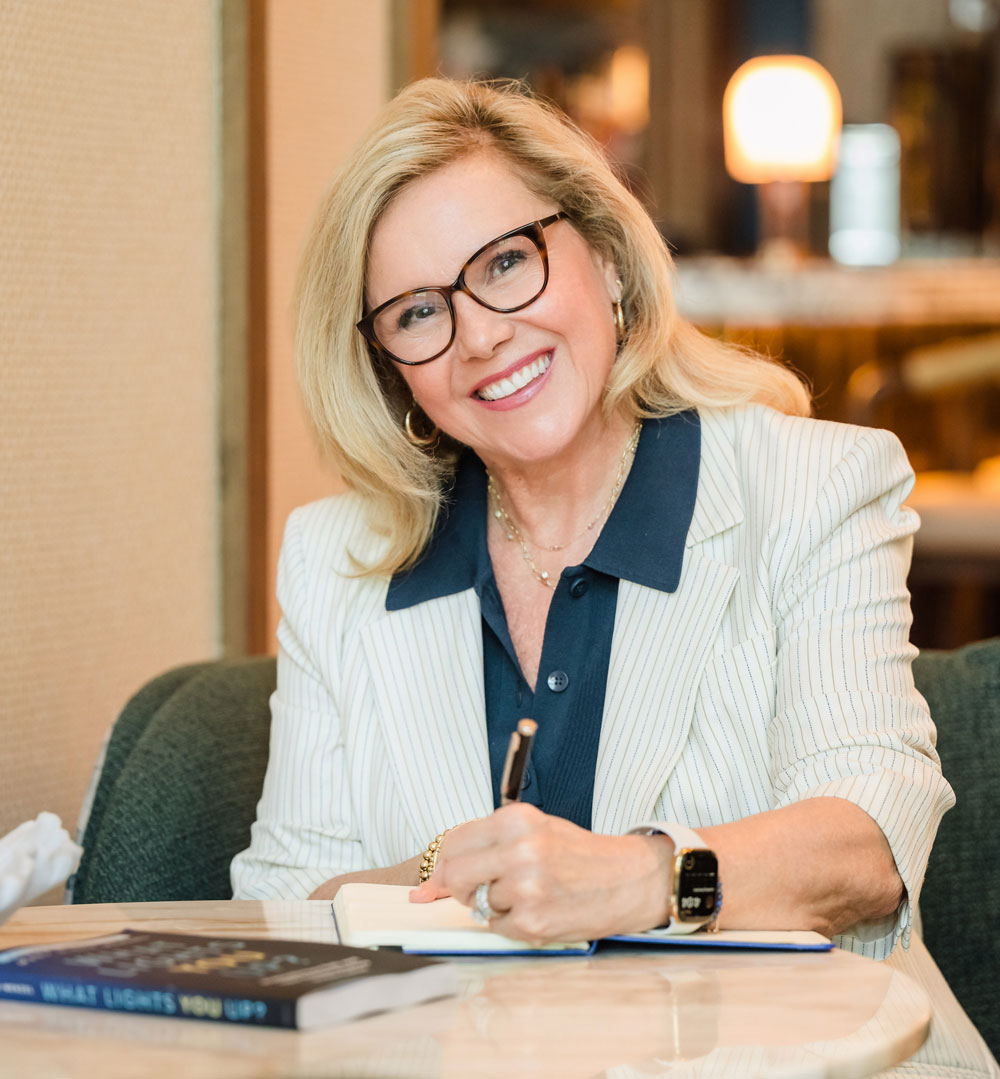 Mary Olson-Menzel signing her bestselling book What Lights You Up?